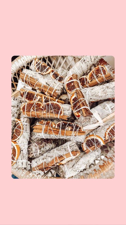 Orange slices and cinnamon with white sage bundle